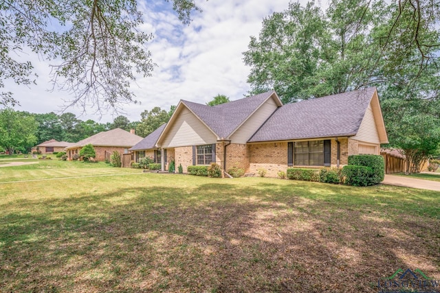 1002 Ruby St, Gilmer, TX 75644 - view of front of home with brick siding, roof with shingles, a front yard, and a garage