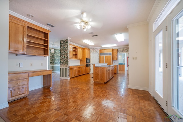 807 Vicksburg Ct, Longview, TX 75601 - kitchen featuring open shelves, ceiling fan, built in desk, a kitchen island, and light countertops
