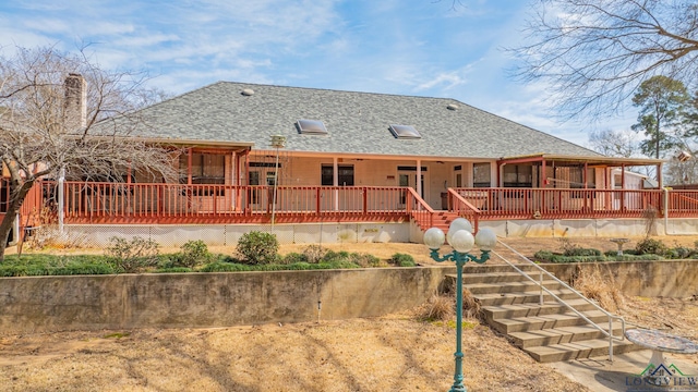807 Vicksburg Ct, Longview, TX 75601 - back of property featuring roof with shingles, stairway, and a deck