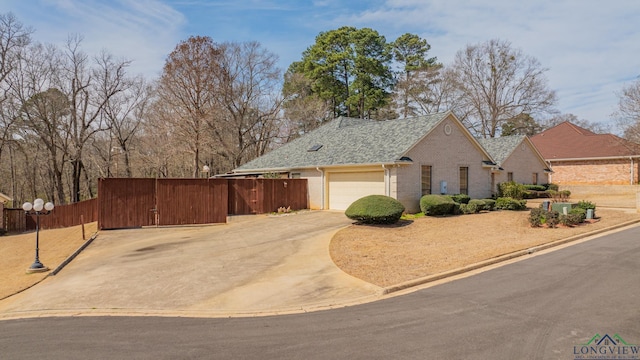 807 Vicksburg Ct, Longview, TX 75601 - view of front facade featuring brick siding, an attached garage, driveway, a gate, and a shingled roof