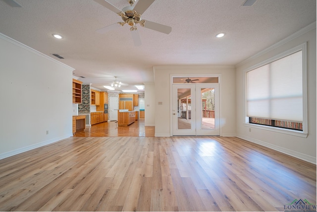 807 Vicksburg Ct, Longview, TX 75601 - unfurnished living room with a ceiling fan, crown molding, a textured ceiling, light wood-style flooring, and recessed lighting