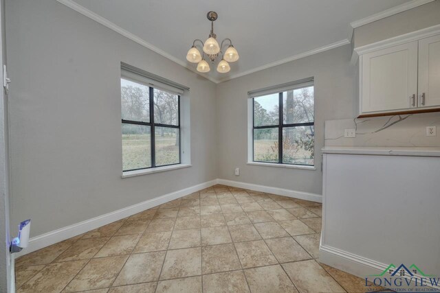 laundry room featuring light tile patterned floors, crown molding, and washing machine and dryer