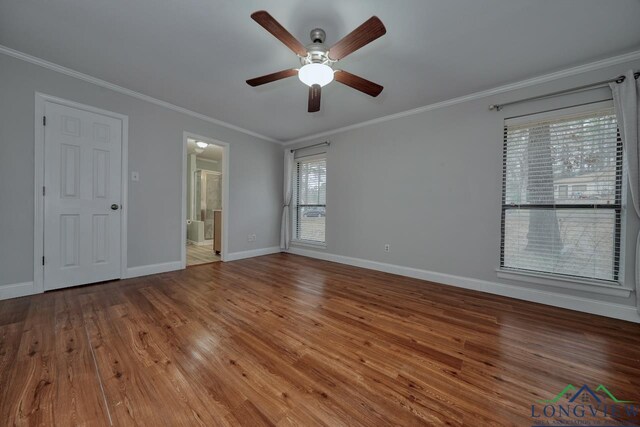 unfurnished bedroom with hardwood / wood-style floors, ensuite bath, ornamental molding, and ceiling fan