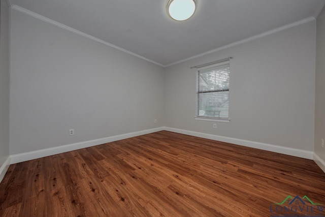 empty room featuring ornamental molding and hardwood / wood-style floors