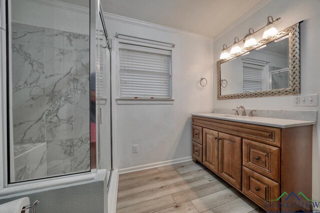 bathroom with toilet, an enclosed shower, ornamental molding, vanity, and hardwood / wood-style floors