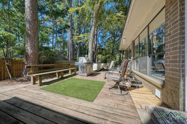 wooden terrace with area for grilling