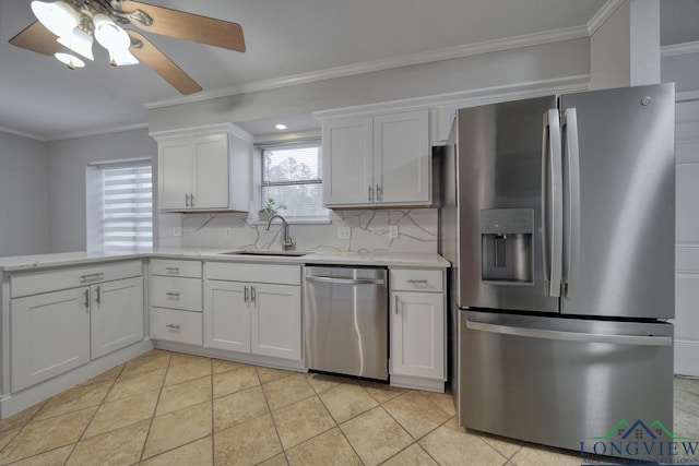 kitchen featuring sink, crown molding, white cabinets, stainless steel appliances, and backsplash