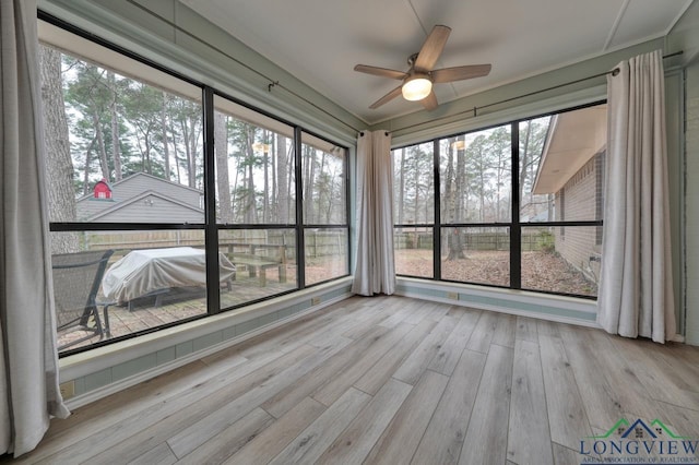 unfurnished sunroom with a healthy amount of sunlight and ceiling fan