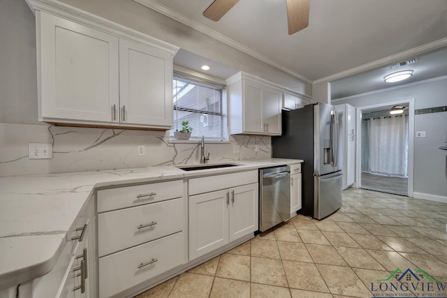 kitchen with appliances with stainless steel finishes, sink, and white cabinets