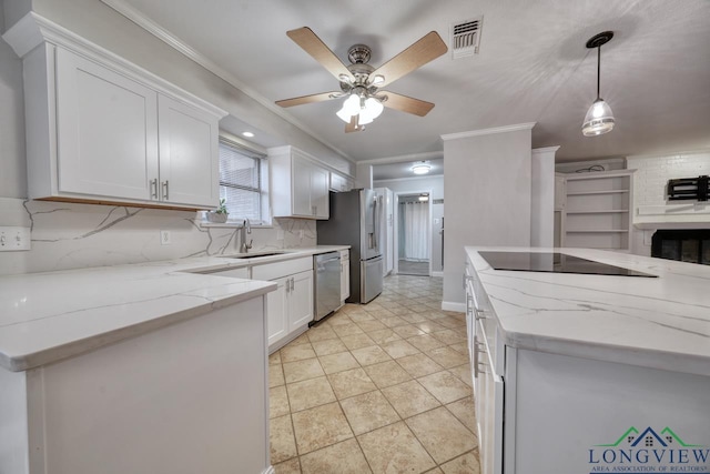 kitchen featuring sink, crown molding, decorative light fixtures, appliances with stainless steel finishes, and white cabinets