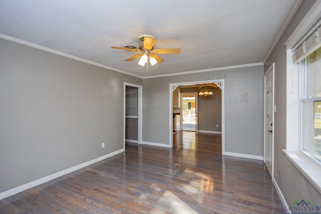 unfurnished room featuring ceiling fan with notable chandelier, dark hardwood / wood-style floors, and crown molding