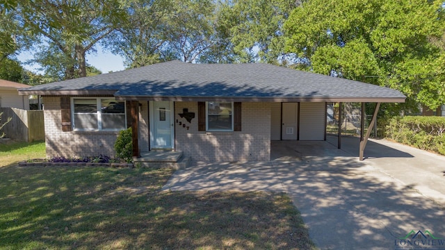 ranch-style home with a front yard and a carport