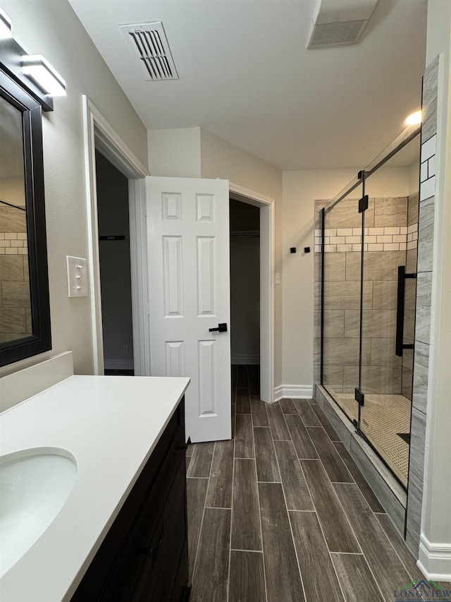 bathroom with vanity and an enclosed shower