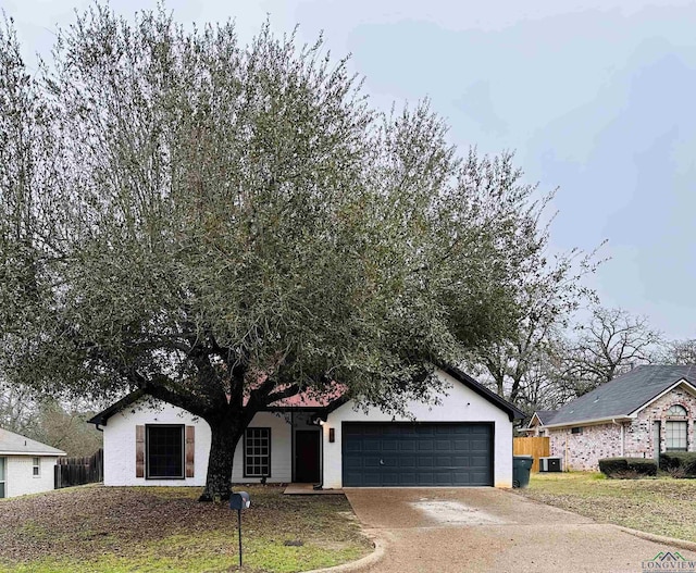 view of front of home with central AC and a garage