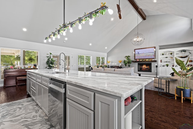22732 Interstate 20e, Winona, TX 75792 - kitchen with stainless steel dishwasher, high vaulted ceiling, wood finished floors, beam ceiling, and a warm lit fireplace