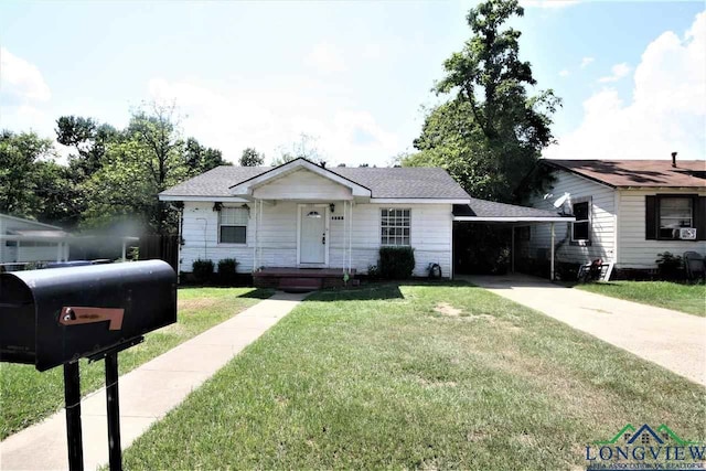 bungalow-style home featuring driveway, a front lawn, an attached carport, and roof with shingles