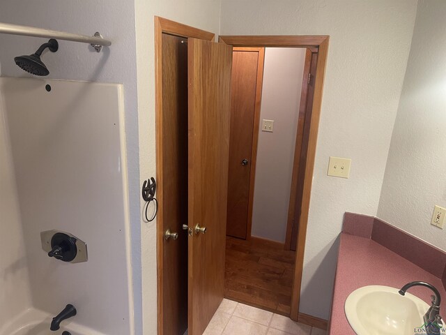 1483 County Road 1596, Avinger, TX 75630 - full bathroom featuring a sink,  shower combination, and tile patterned floors