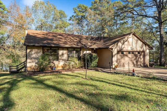 1483 County Road 1596, Avinger, TX 75630 - view of front of home featuring a garage, concrete driveway, and a front yard