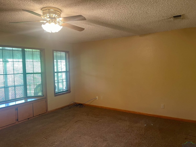 1483 County Road 1596, Avinger, TX 75630 - unfurnished room with carpet floors, ceiling fan, a textured ceiling, and baseboards
