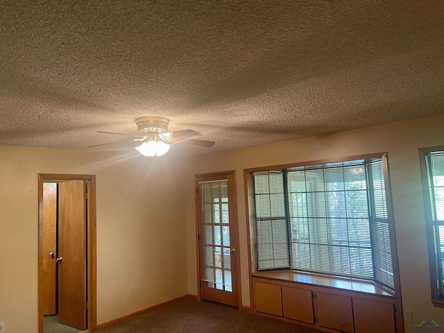 1483 County Road 1596, Avinger, TX 75630 - empty room featuring carpet, a ceiling fan, a textured ceiling, and baseboards