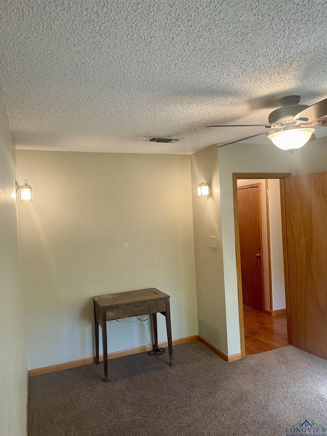 1483 County Road 1596, Avinger, TX 75630 - hallway with carpet flooring, a textured ceiling, and baseboards