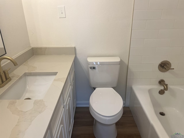 full bathroom featuring vanity, hardwood / wood-style flooring, toilet, and tiled shower / bath combo