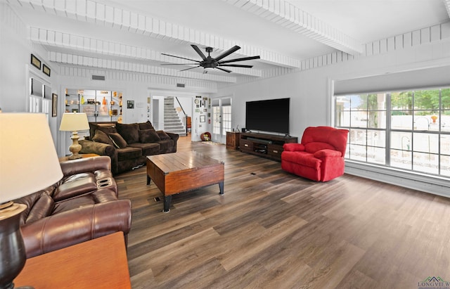 living room featuring ceiling fan, dark hardwood / wood-style flooring, and beamed ceiling