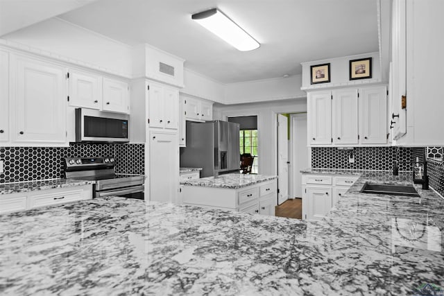 kitchen featuring sink, white cabinetry, and stainless steel appliances