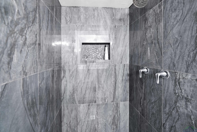 bathroom with a tile shower