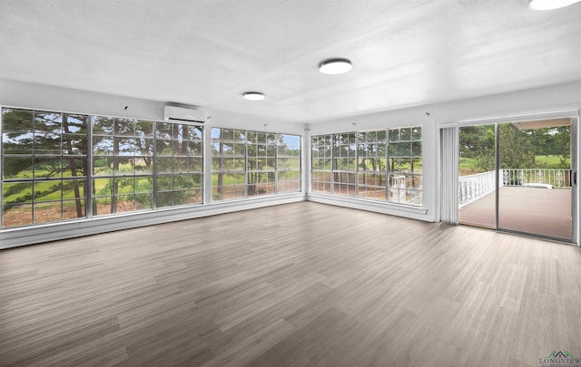 unfurnished sunroom featuring an AC wall unit