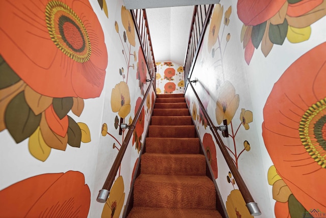 staircase featuring lofted ceiling