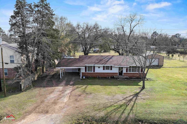 view of front of house with a front lawn and a carport