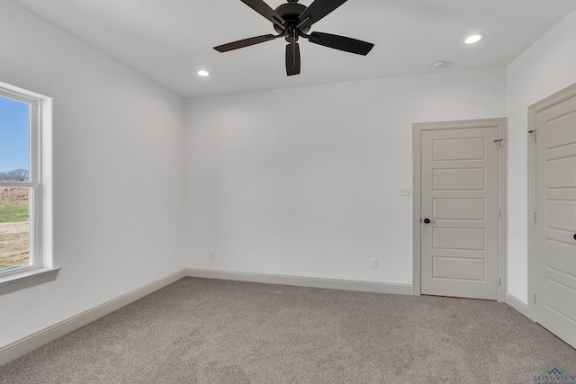 carpeted empty room with ceiling fan