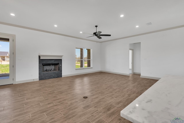 unfurnished living room with ceiling fan and ornamental molding