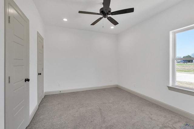 unfurnished room featuring light carpet and ceiling fan