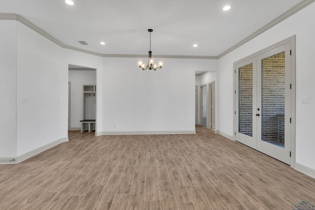 unfurnished room with french doors, light hardwood / wood-style floors, ornamental molding, and a notable chandelier