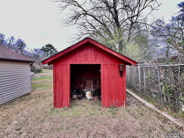 view of shed featuring fence