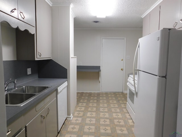 200 Hickory St, Gladewater, TX 75647 - kitchen with white appliances, ornamental molding, light floors, dark countertops, and a textured ceiling