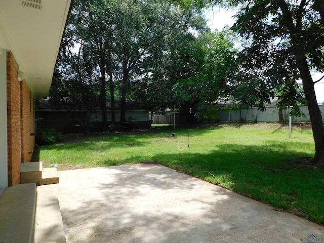 200 Hickory St, Gladewater, TX 75647 - fenced backyard featuring a patio area