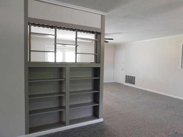 200 Hickory St, Gladewater, TX 75647 - unfurnished room featuring a textured ceiling, carpet flooring, a ceiling fan, and ornamental molding