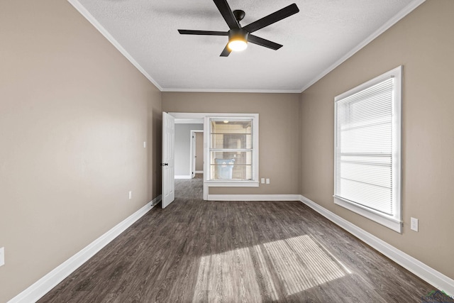 spare room with ceiling fan, dark hardwood / wood-style floors, a textured ceiling, and ornamental molding