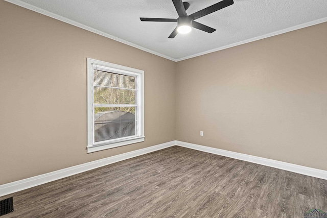 spare room featuring dark hardwood / wood-style floors, ornamental molding, and a textured ceiling