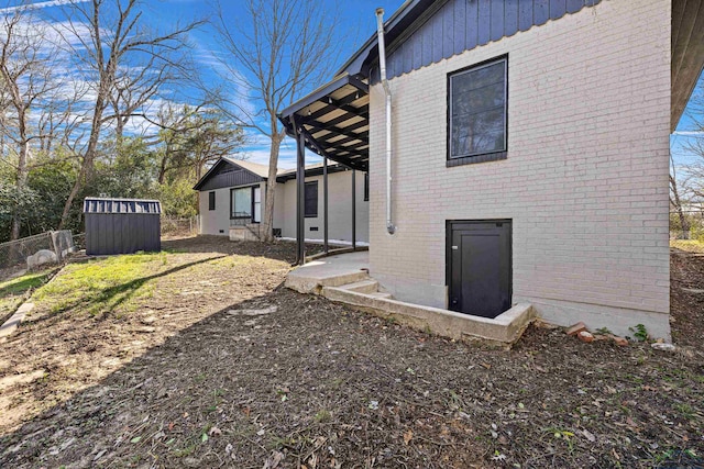 view of side of home with a storage shed