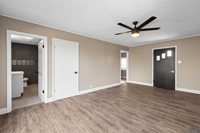 interior space with ceiling fan, a textured ceiling, and hardwood / wood-style floors