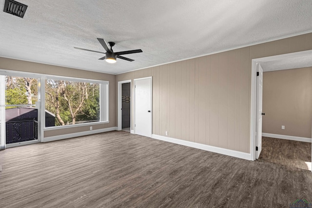 interior space with ceiling fan, dark wood-type flooring, and a textured ceiling