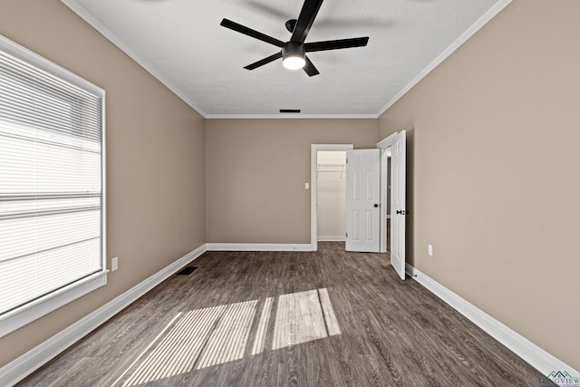 spare room with ceiling fan, wood-type flooring, ornamental molding, and a textured ceiling