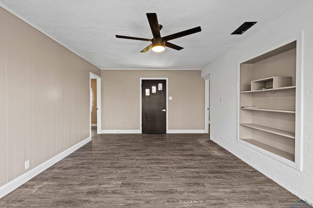 foyer entrance featuring a textured ceiling, ceiling fan, and dark wood-type flooring