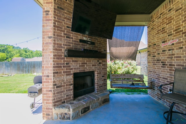 view of patio featuring an outdoor brick fireplace