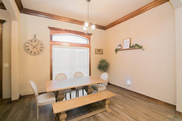 dining space with a chandelier, ornamental molding, and dark wood-type flooring