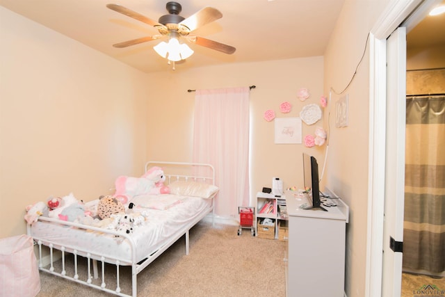 carpeted bedroom featuring ceiling fan and a closet